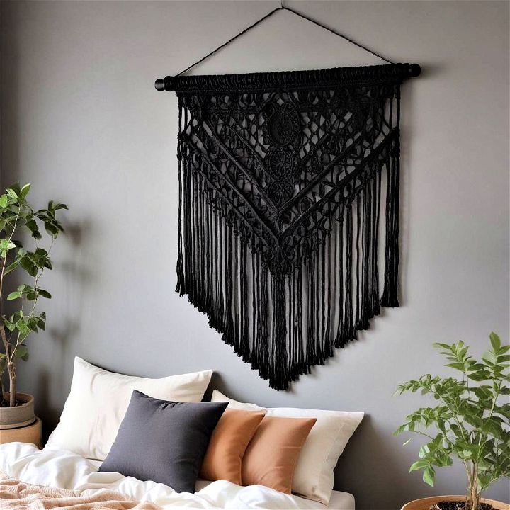 black accent wall with a black macramé hanging