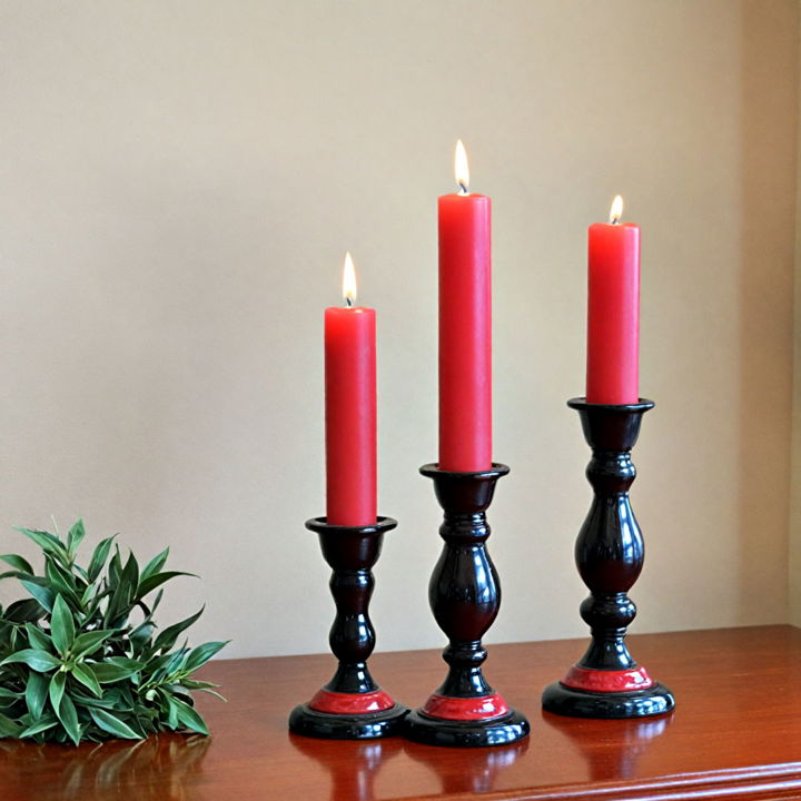 elegant candles in red and black holders