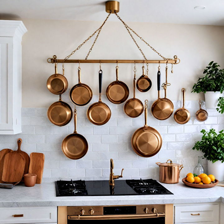 gold pot rack against white kitchen wall