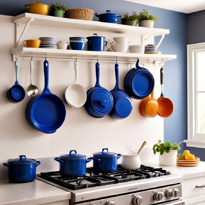 white pot rack with blue pots and pans