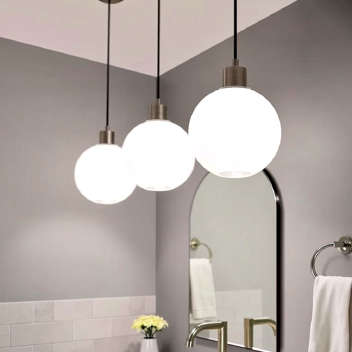 glass globe pendant lights above the vanity