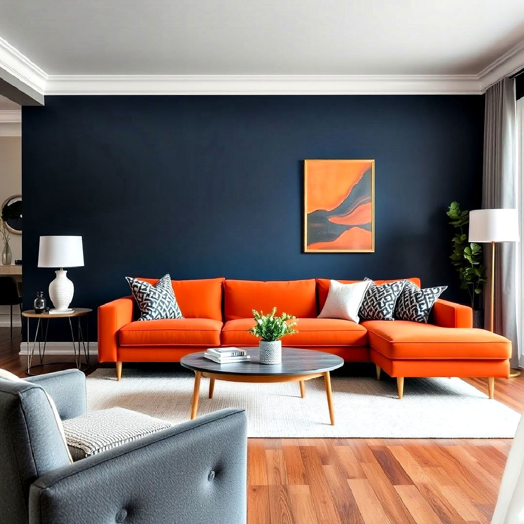 navy blue feature wall with a bold orange sofa
