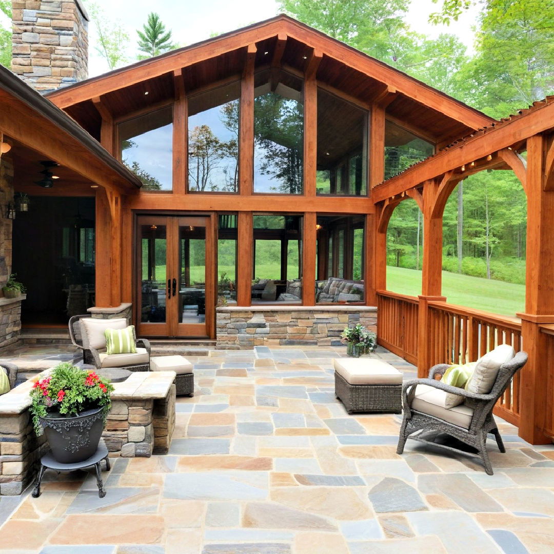 wood framed sunroom with stone deck idea